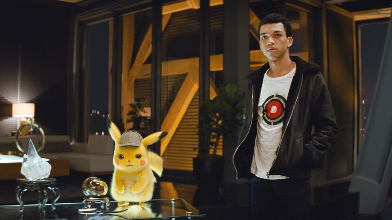 Detective Pikachu (Ryan Reynolds) and Tim Goodman (Justice Smith) examine clues in Detective Pikachu (2019)