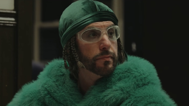 Sacha Baron Cohen's Ali G looks off to his right in closeup in Ali G Who Iz I?