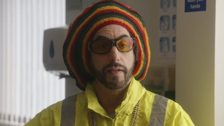 Sacha Baron Cohen's Ali G is seen in closeup as he sits in a doctor's office in Ali G Who Iz I?