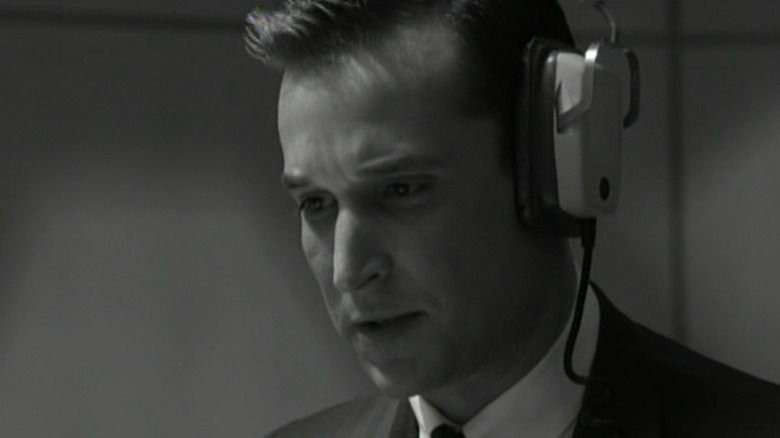 Noah Wyle's Buck wears headphones and looks concerned in closeup in Fail Safe