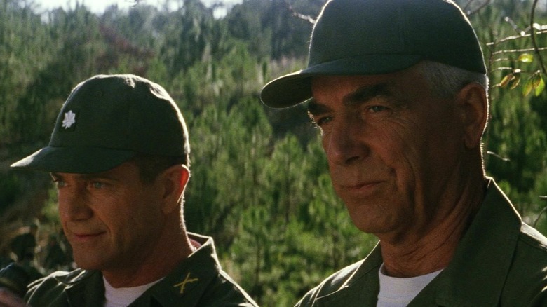 Mel Gibson's Lt. Col. Hal Moore holds a pair of binoculars as he stands next to Sam Elliott's Sgt. Maj. Basil Plumley in We Were Soldiers