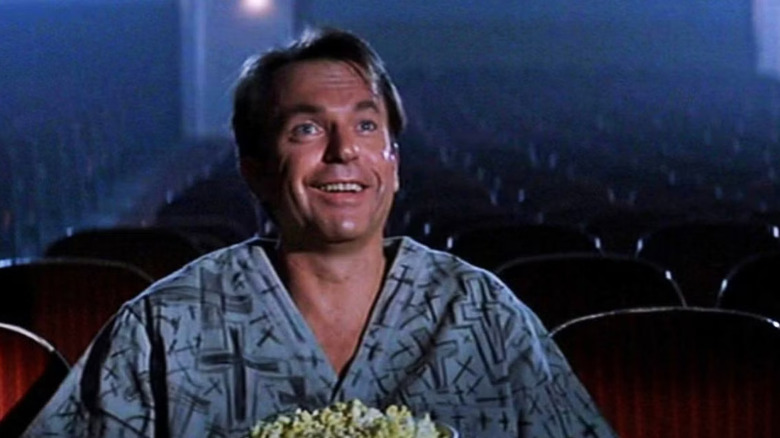 John Trent smiling at the end of In The Mouth of Madness
