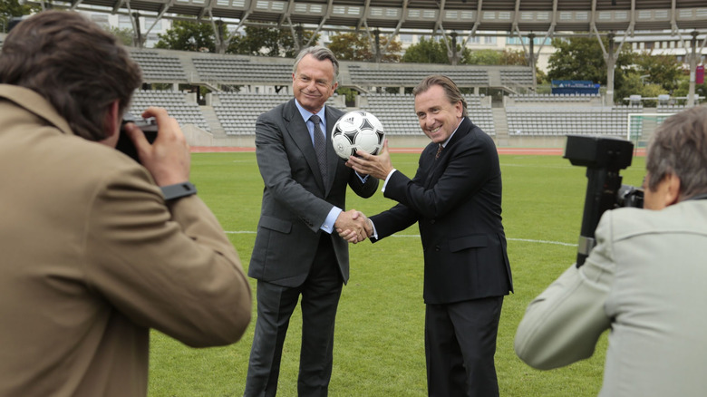 João Havelange and Sepp Blatter holding a soccer ball during a press conference in United Passions