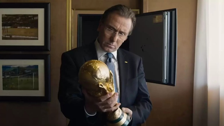 Sepp Blatter holding a World Cup trophy in United Passions