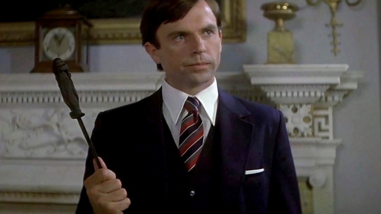 Damien holding a dagger by the blade in The Final Conflict