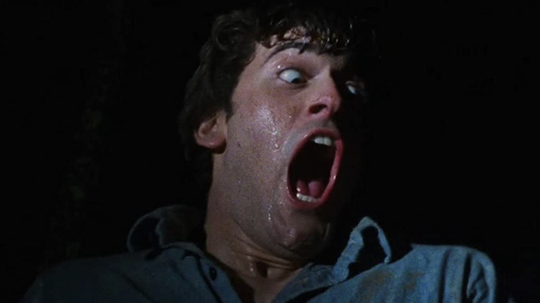 Ash Williams screaming and sweating in The Evil Dead