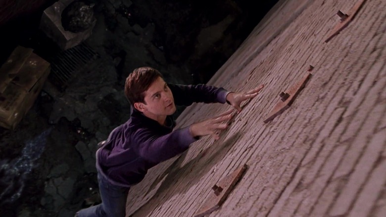 Peter Parker climing a wall in Spider-Man