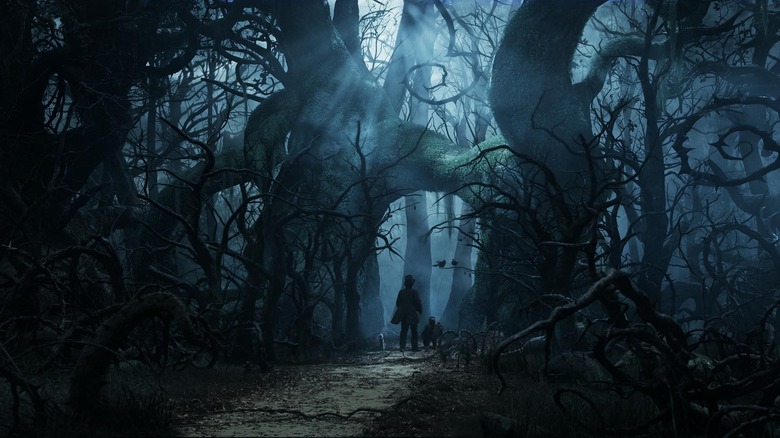 James Franco as Oscar and Zach Braff as Finley entering a dark forest in Oz the Great and Powerful