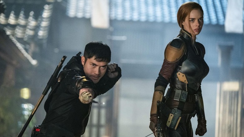 Henry Golding as Snake Eyes and Samara Weaving as Scarlett getting ready to fight in Snake Eyes: G.I. Joe Origins