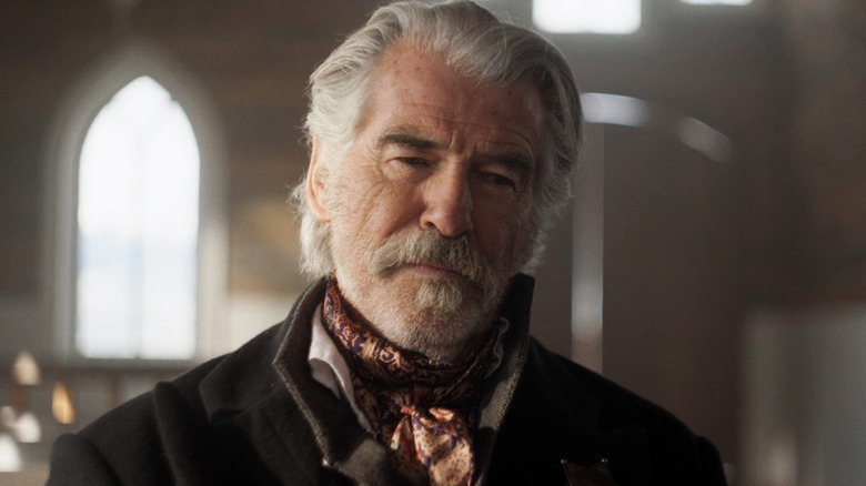 Pierce Brosnan's Gabriel Dove sits in a church in The Unholy Trinity