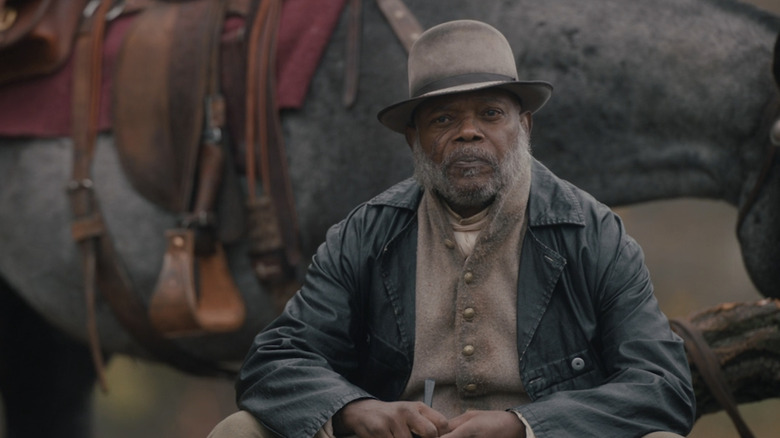 Samuel L. Jackson's St. Christopher sits next to a horse in The Unholy Trinity