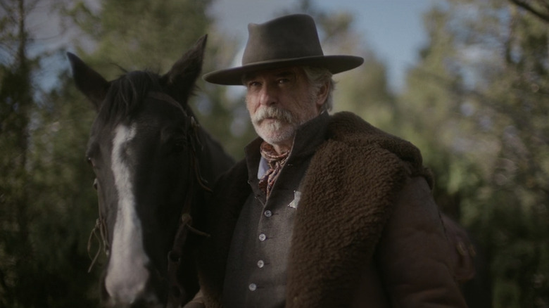Pierce Brosnan's Gabriel Dove stands next to his horse in The Unholy Trinity