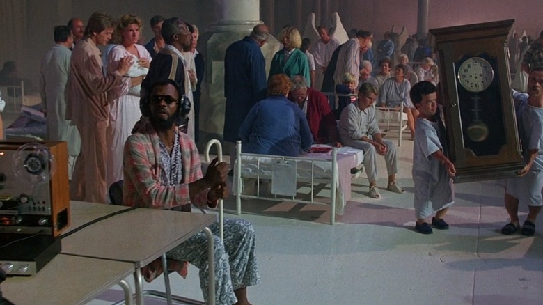The Dream Blind Man sits by a radio surrounded by angels in The Exorcist III