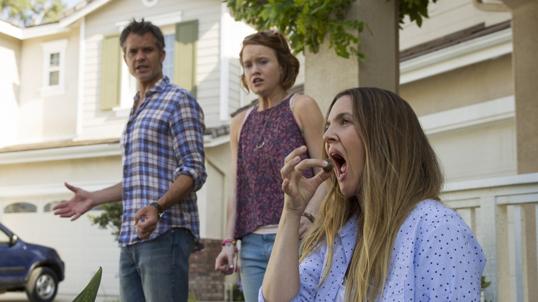 Joel and Abby looking at Sheila eating a finger