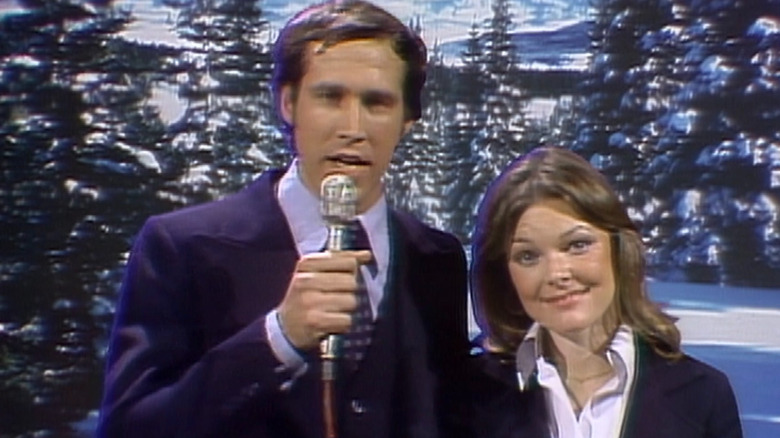 Announcers (Chevy Chase and Jane Curtin) on ski slopes on Saturday Night Live