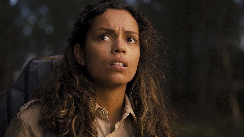 Georgina Campbell as Lennon, scared in the forest, in Lovely, Dark, and Deep