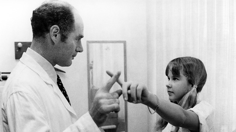 Regan with doctor in The Exorcist