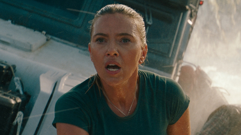 Scarlett Johansson as Zora Bennett on the front of a boat headed towards some rocks in Jurassic World Rebirth