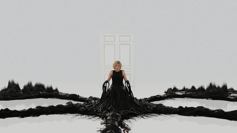 Lucy turning into a sci-fi tendril creature in Lucy (2014)