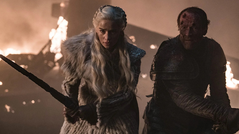 Emilia Clarke as Daenerys wielding a sword to defend Jorah in Game of Thrones (2019)