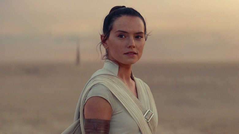 Daisy Ridley as Rey smiling on Tatooine at the end of The Rise of Skywalker (2019)