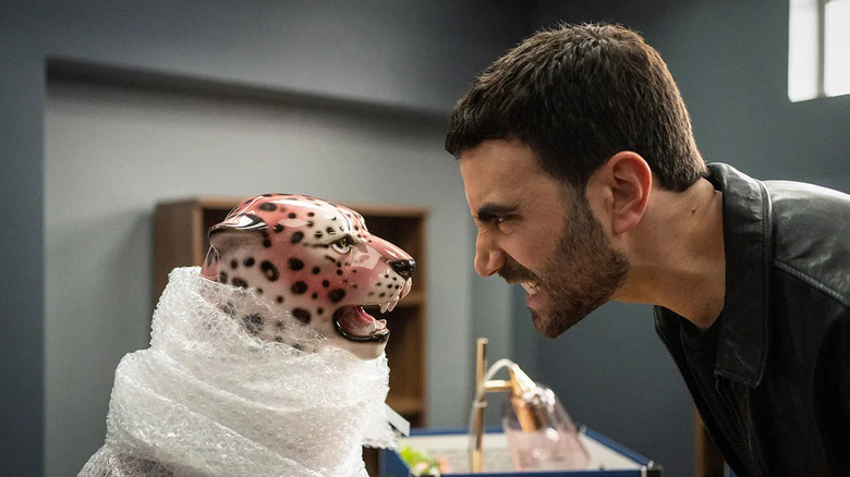 Brett Goldstein as Roy growling at a pink cheetah statue in Ted Lasso (2021)
