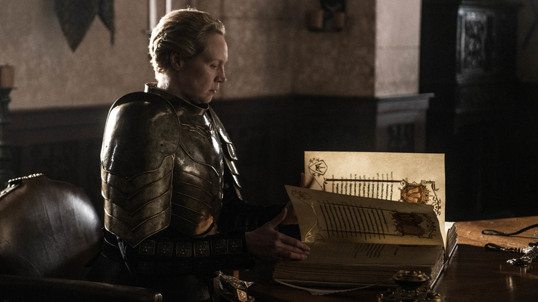 Brienne of Tarth writing in a book at the end of Game of Thrones