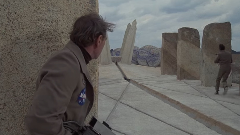Men running through stone structures in The Martian Chronicles