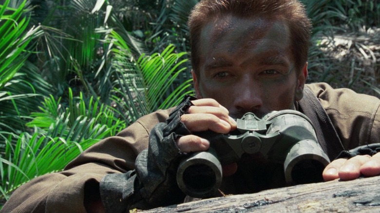 Dutch looking through binoculars in Predator