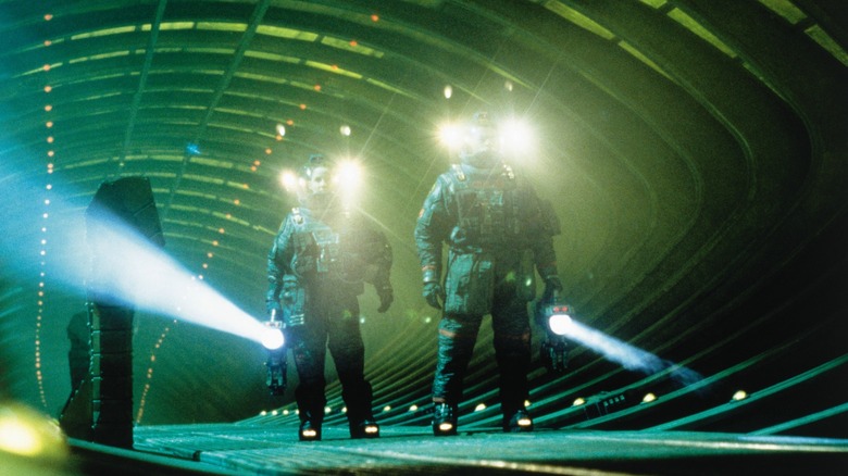 Starck and Miller walking  through a tunnel in their spacesuits in Event Horizon