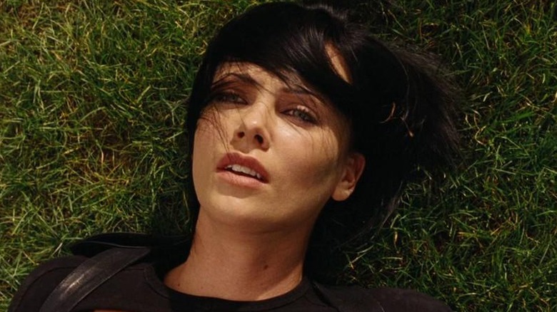 Charlize Theron laying in grass