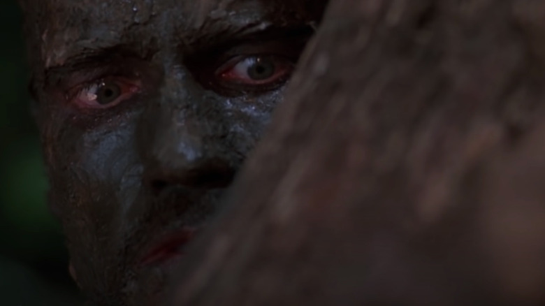 Arnold Schwarzenegger hiding from Predator