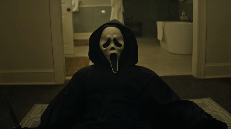 Ghostface chasing someone around a house in Scream 7