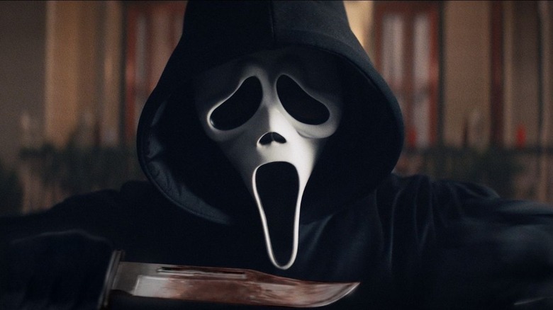 ghostface from scream holding a bloody knife