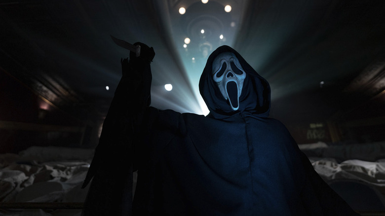 Scream 6's Ghostface with a knife in a theater