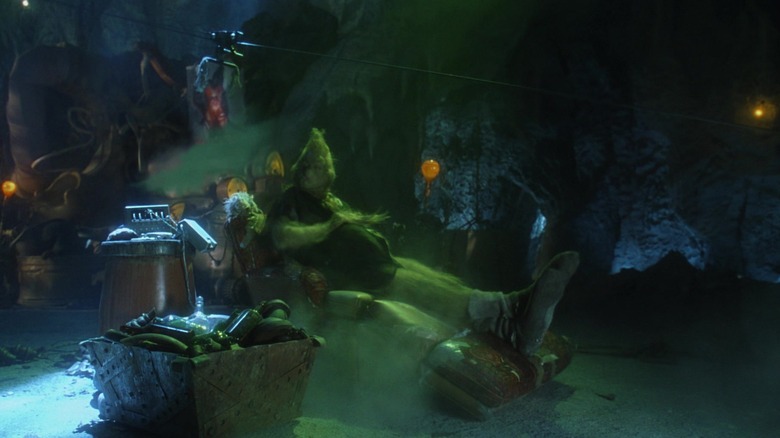 Jim Carrey's Grinch sits in his chair in his lair in How the Grinch Stole Christmas
