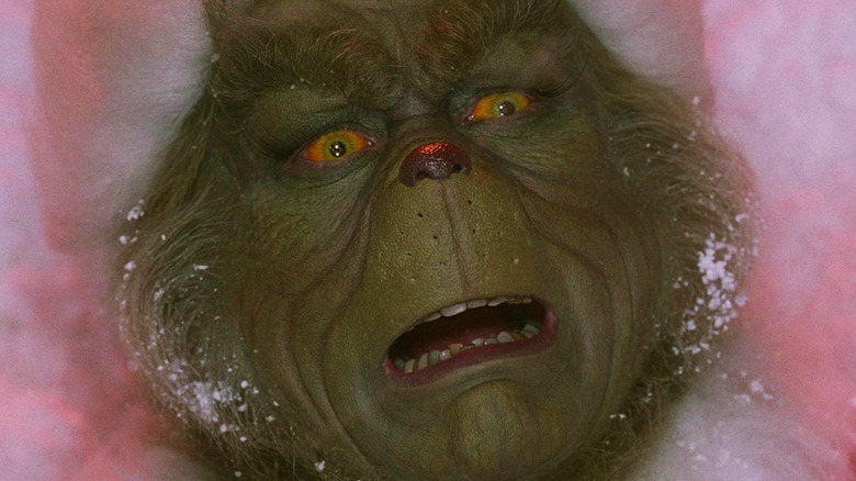 Jim Carrey's Grinch is seen looking upset in closeup in How the Grinch Stole Christmas