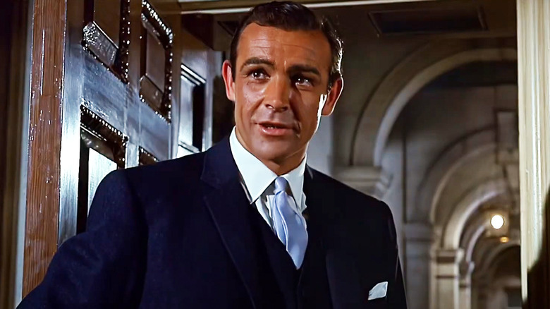 Sean Connery's Anthony Richmond stands in a doorway in Woman of Straw