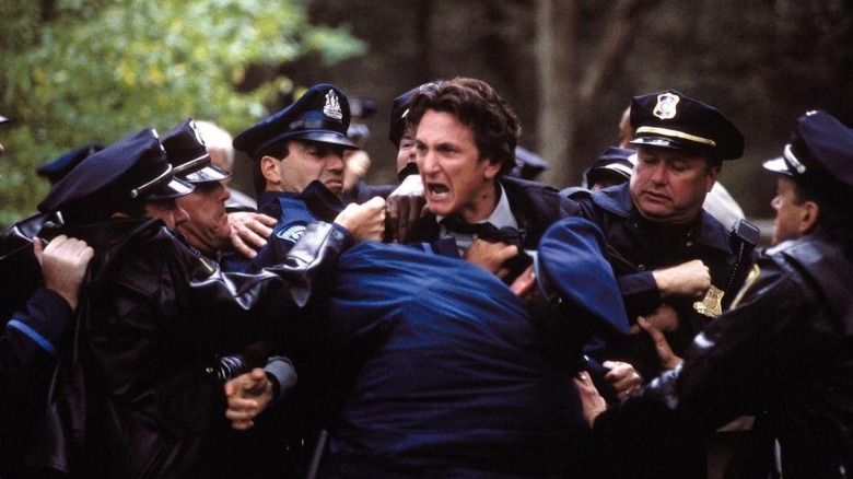 Sean Penn yelling and held by police