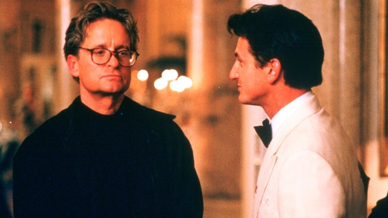 Sean Penn in tuxedo talks to Michael Douglas