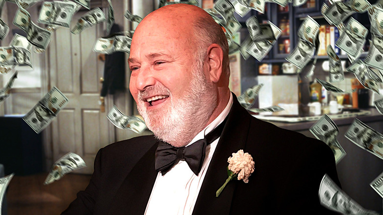 A composite image of Rob Reiner surrounded by piles of cash superimposed against the Seinfeld apartment from Seinfeld