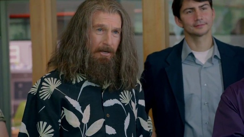 Nathan Flomm, wearing a Hawaiian shirt with long flowing hair and a bushy beard, looks dumbfounded with his mouth open in "Clear History"