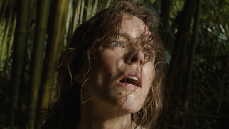 Rachel McAdams as Linda standing in a forrest of bamboo in Send Help