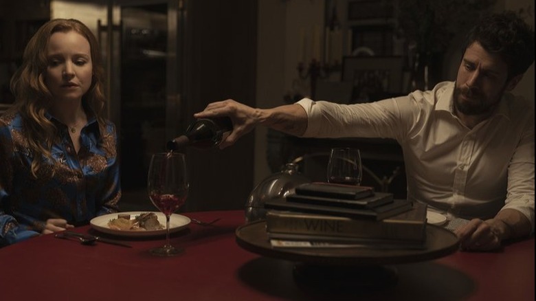 Husband pours wine for wife