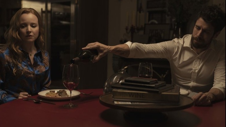 Husband pours wine for wife