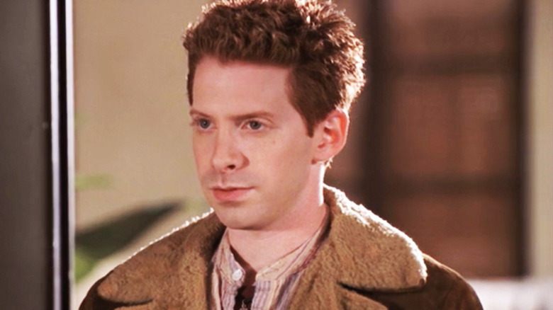 Oz stands in a doorway in Buffy the Vampire Slayer