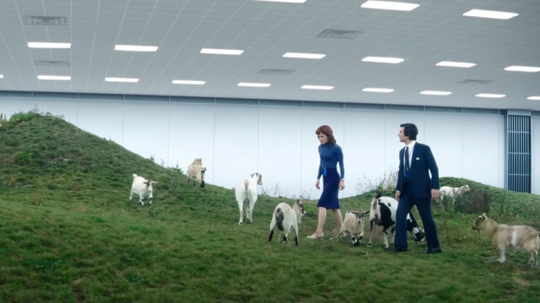 Adam Scott in the role of Mark S. and Britter Lower as Heli R. Walking by the goat group in breaking