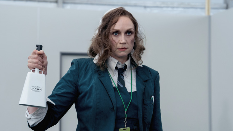Gwendoline Christie's Lorne looking disheveled and holding a bell on Severance
