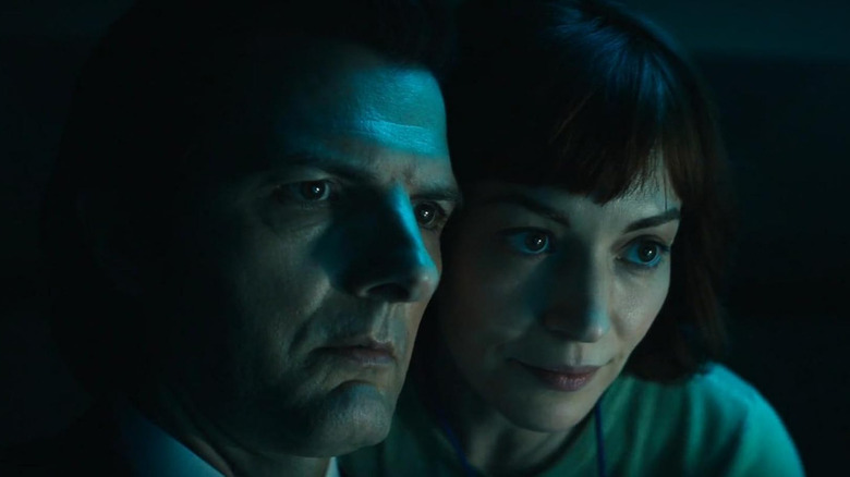 Innie Mark and Helly looking at a screen together in Severance