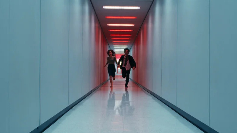 Helly and Mark running down a red-lit hallway in Severance